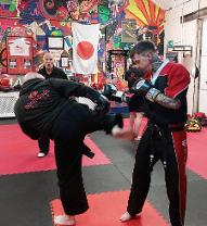 Kickboxing instructor Rob is coaching a student