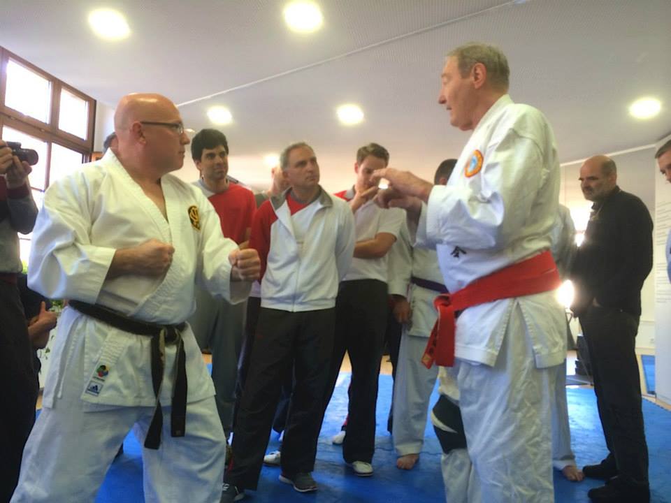 Sensei Charles facing another high ranking instructor, receiving instruction.